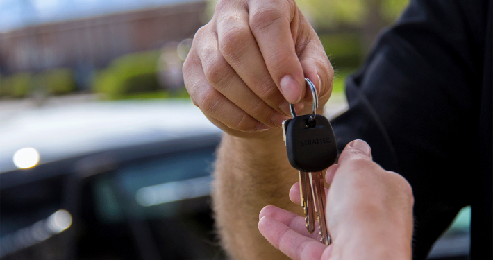 Image of man handing keys to another person