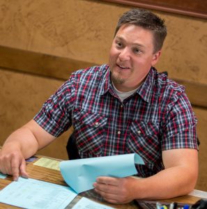 Automotive repair staff member at desk